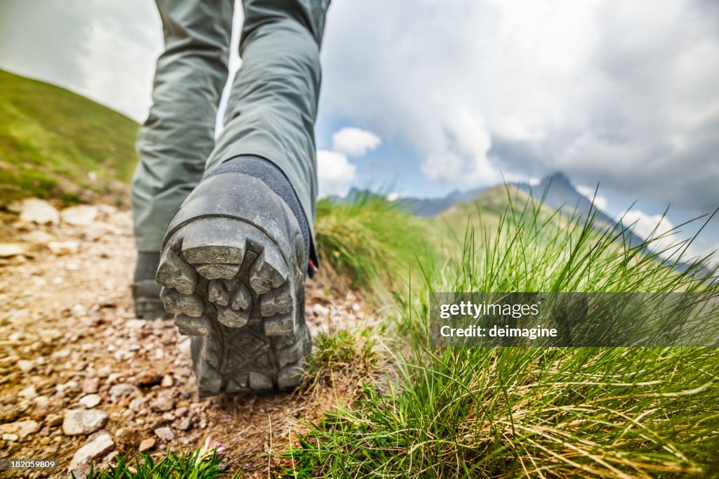 Hiker walks on Mountain Trail