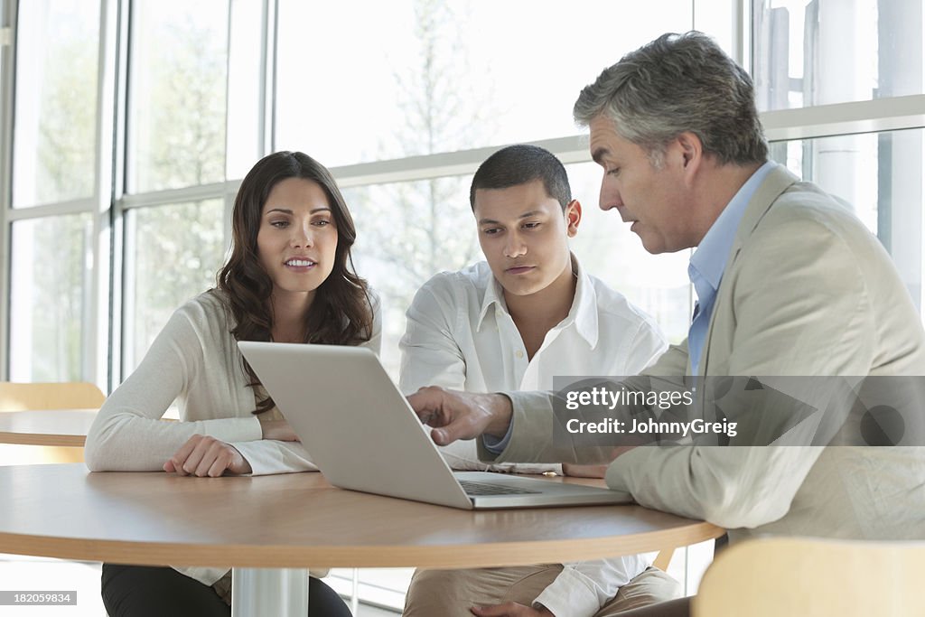Man Explaining an Investment Plan To Couple