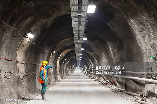 pointing downward in a tunnel/mine - mining natural resources stock pictures, royalty-free photos & images