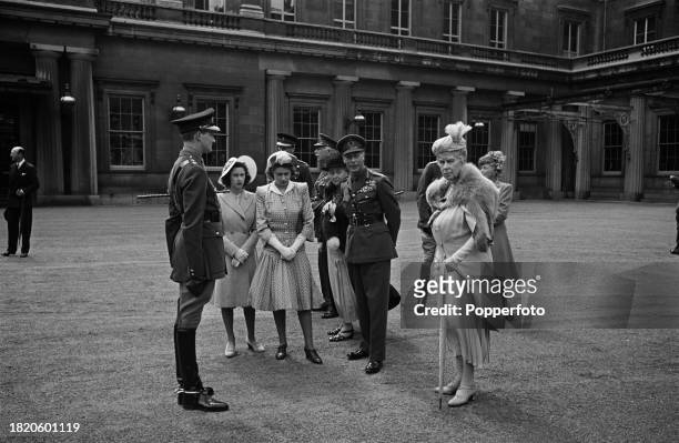 Members of the British royal family, from left, Princess Margaret Rose , Princess Elizabeth , King George VI and Queen Mary of Teck stand with, in...