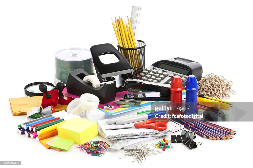 Large assortment of office supplies on white backdrop
