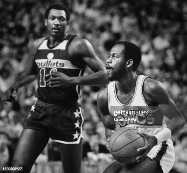 American basketball player Gus Williams, Seattle SuperSonics point guard, under pressure from American basketball player Elvin Hayes, Washington...