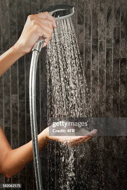 testing the shower temperature (xxxl) - cold shower stock pictures, royalty-free photos & images