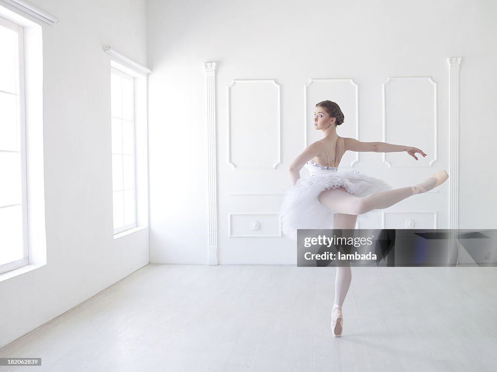 Ballet dancer in white studio