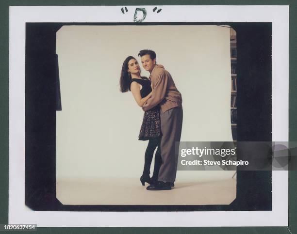 Portrait of American actors Jennifer Connelly and Frank Whaley, as they embrace in front of a white background, for the film 'Career Opportunities' ,...