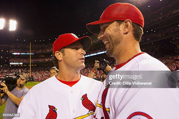Manager Mike Matheny and Adam Wainwright of the St. Louis Cardinals celebrate winning the National League Central Division title against the Chicago...