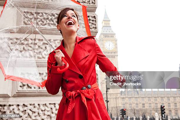 london woman in red with umbrella - trench coat stock pictures, royalty-free photos & images