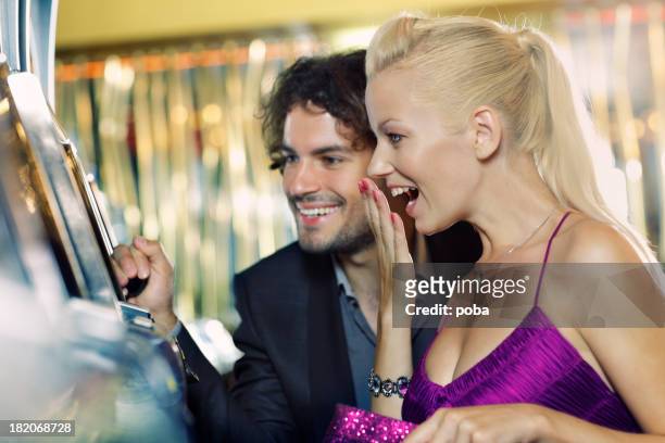 young couple gambling in the casino - lucky wheel stock pictures, royalty-free photos & images