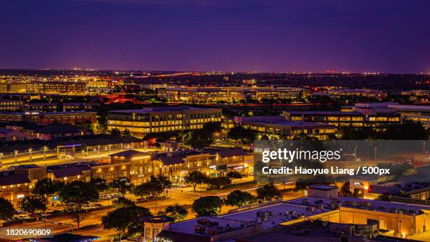 high angle view of illuminated buildings in city at night,plano,texas,united states,usa - plano stock pictures, royalty-free photos & images