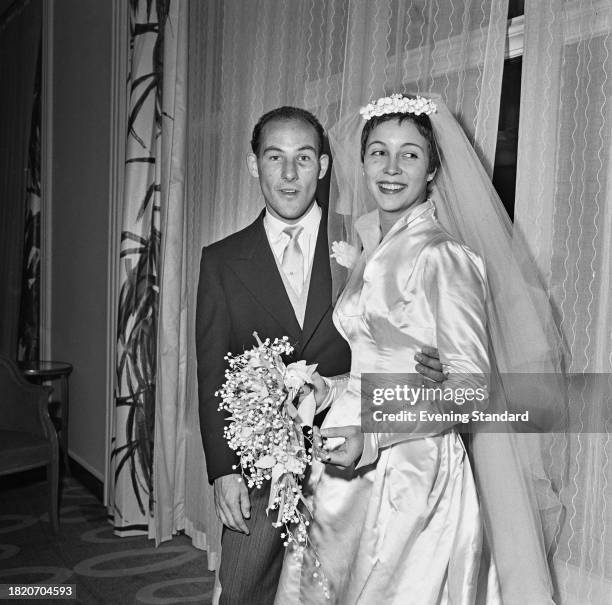 Racing driver Stirling Moss with his wife Katie on their wedding day, St Peter's Church, Eaton Square, London, October 7th 1957.