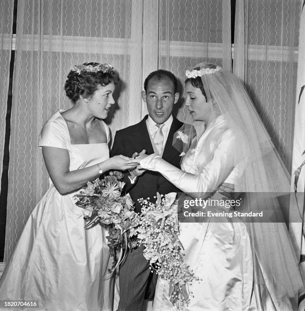 Stirling Moss with his wife Katie on their wedding day, and sister, racing driver Pat Moss , left, St Peter's Church, Eaton Square, London, October...