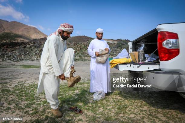 Fadel and his assistant wear bee-protective gear on November 29, 2023 in Sharjah, United Arab Emirates. Fadel Al-Saadi, in his fifties, has been...