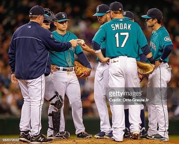 Relief pitcher Oliver Perez of the Seattle Mariners is removed from the game by manager Eric Wedge in the seventh inning against the Oakland...