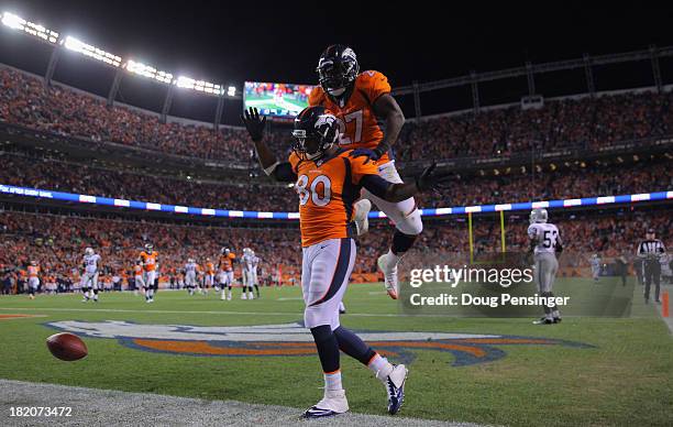 Julius Thomas of the Denver Broncos celebrates his touchdown against the Oakland Raiders with Knowshon Moreno of the Denver Broncos at Sports...