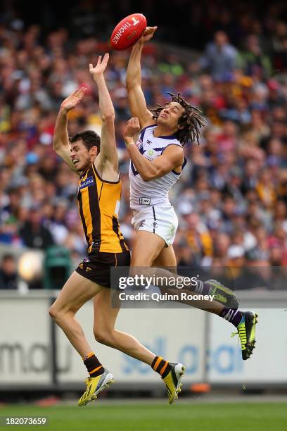 Tendai Mzungu of the Dockers spoils a mark by Isaac Smith of the Hawks during the 2013 AFL Grand Final match between the Hawthorn Hawks and the...