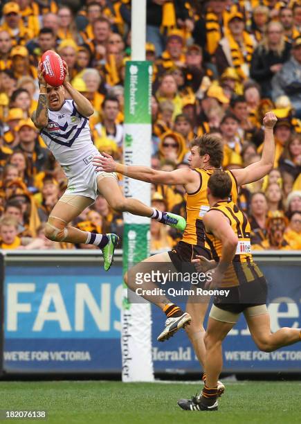Michael Walters of the Dockers marks over the top of Grant Birchall of the Hawks during the 2013 AFL Grand Final match between the Hawthorn Hawks and...