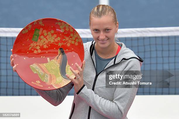 Winner Petra Kvitova of Czech Republic celebrates with her plate after her women's singles final match against Angelique Kerber of Germany during day...