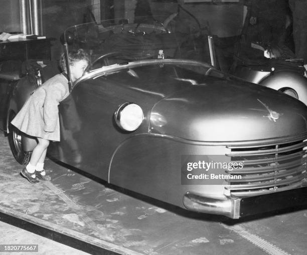 The Bond minicar, a three-wheeled cross between a small car and a motorcycle is on display at the British Cycle and Motorcycle show at Earl's Court...