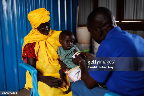 Young boy recovering from measles is bought into a clinic by his mother for MUAC measurements on November 29, 2023 in Rotriak, South Sudan. The young...