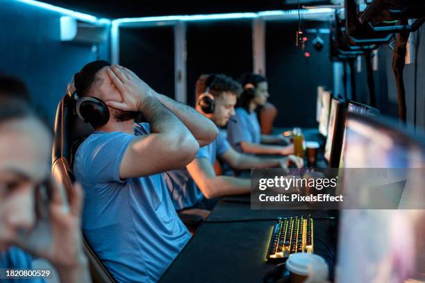 angry computer gamer man after being defeated in online video game - microsoft media & entertainment group stock pictures, royalty-free photos & images