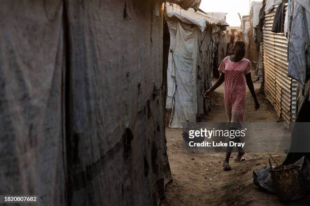 Lady walks though an Internally Displaced Persons camp on November 29, 2023 in Bentiu, South Sudan. Climate change has divided South Sudan into land...