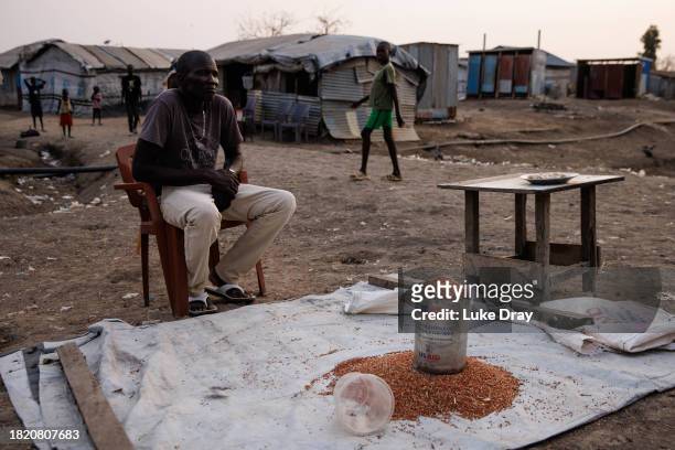 Man sells sourgum, thought to be donated by USAID, in an Internally Displaced Persons camp on November 29, 2023 in Bentiu, South Sudan. Climate...