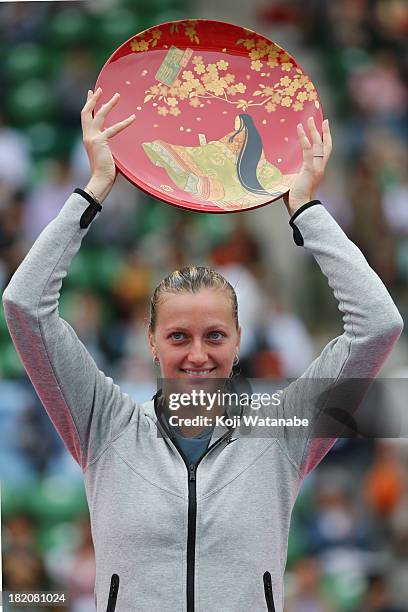 Winner Petra Kvitova of Czech Republic celebrates with her plate after her women's singles final match against Angelique Kerber of Germany during day...