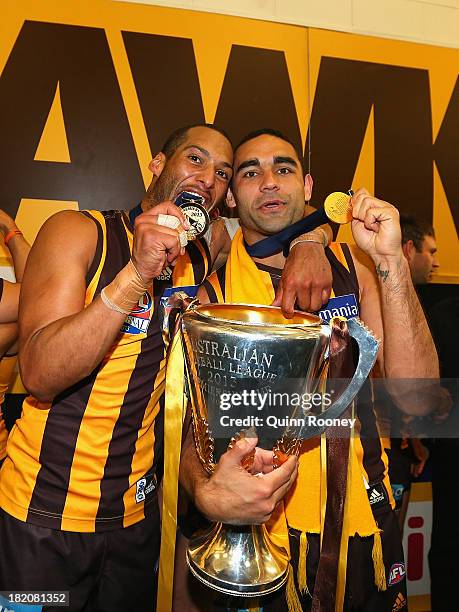 Josh Gibson and Shaun Burgoyne of the Hawks celebrate with the Premiership Cup after the hawks won the 2013 AFL Grand Final match between the...