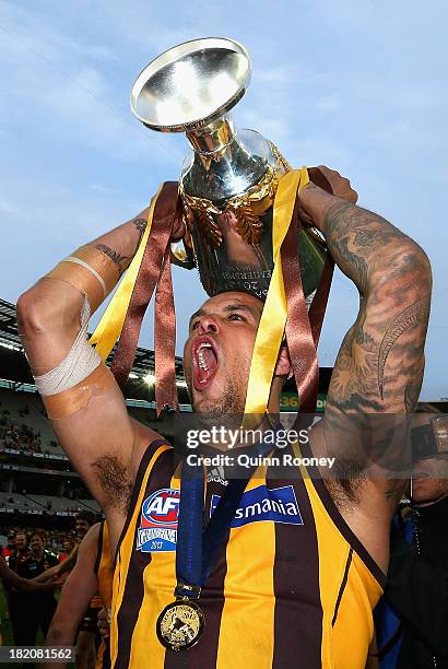 Lance Franklin of the Hawks celebrates with the Premiership Cup after the hawks won the 2013 AFL Grand Final match between the Hawthorn Hawks and the...