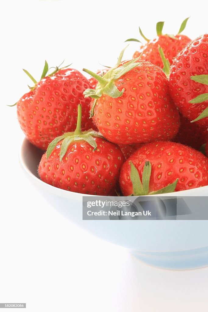 Strawberries in bowl on white