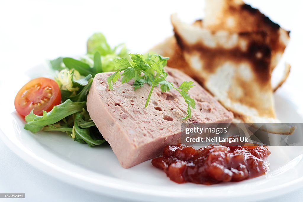 Pate with melba toast, chutney and salad on white