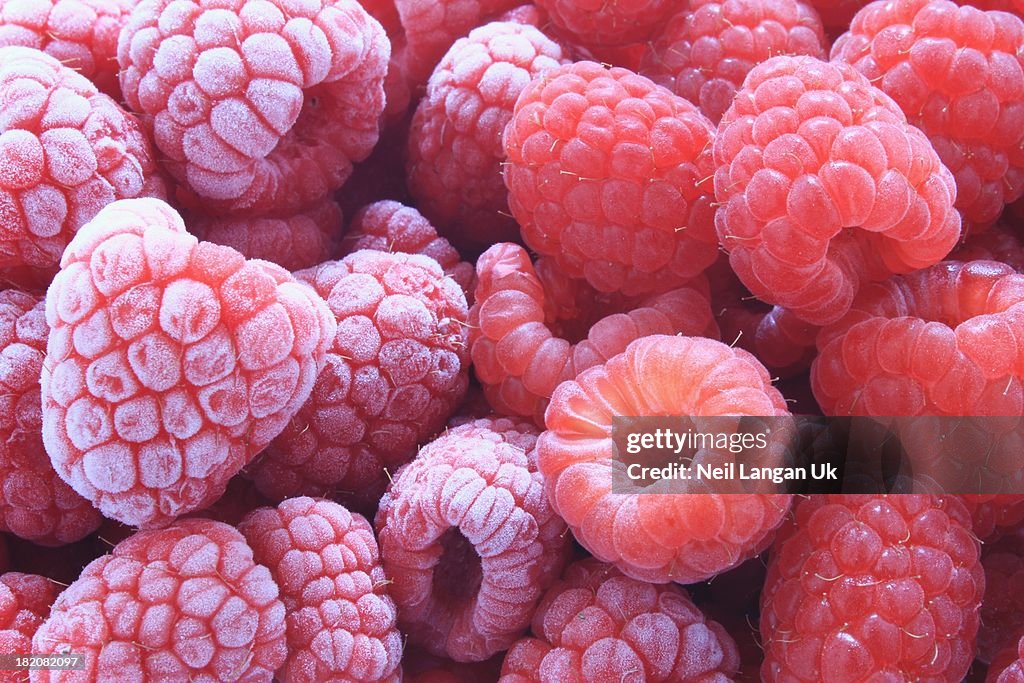 Fresh and frozen raspberries close up