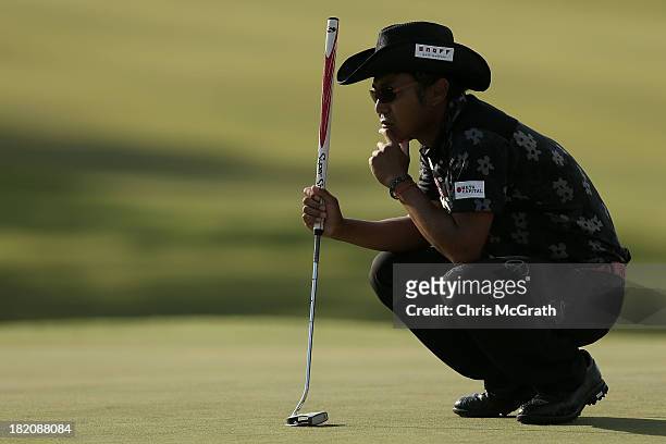 Shingo Katayama of Japan lines up his putt on the 18th green during day three of the Panasonic Japan Open at Ibaraki Golf Club on September 28, 2013...