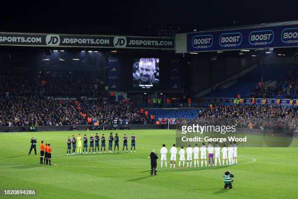 The players, fans and match officials pause for a minutes applause following the recent passing of former English football player and manager, Terry...