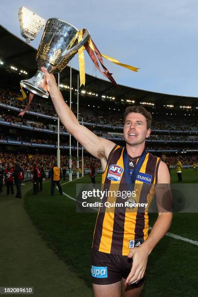 Jonathan Simpkin of the Hawks celebrates with the Premiership Cup after the Hawks won the 2013 AFL Grand Final match between the Hawthorn Hawks and...