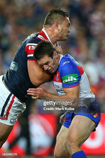 Danny Buderus of the Knights tackles Jared Waerea-Hargreaves of the Roosters during the NRL Preliminary Final match between the Sydney Roosters and...