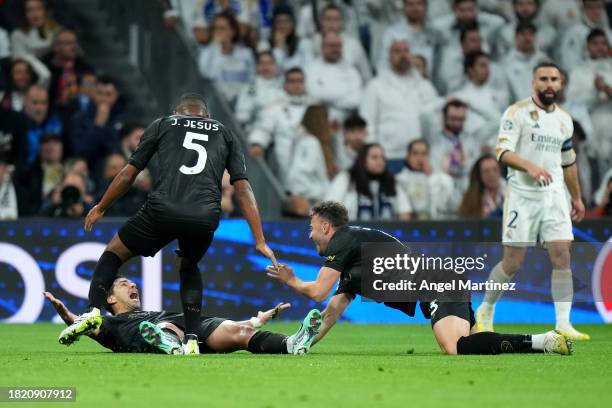 Giovanni Simeone of SSC Napoli celebrates with teammates Juan Jesus and Amir Rrahmani after scoring the team's first goal during the UEFA Champions...