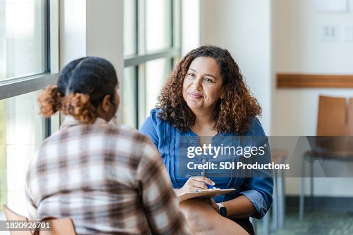 Unrecognizable female university student shares struggles with female therapist Unrecognizable female university student shares struggles with female therapist