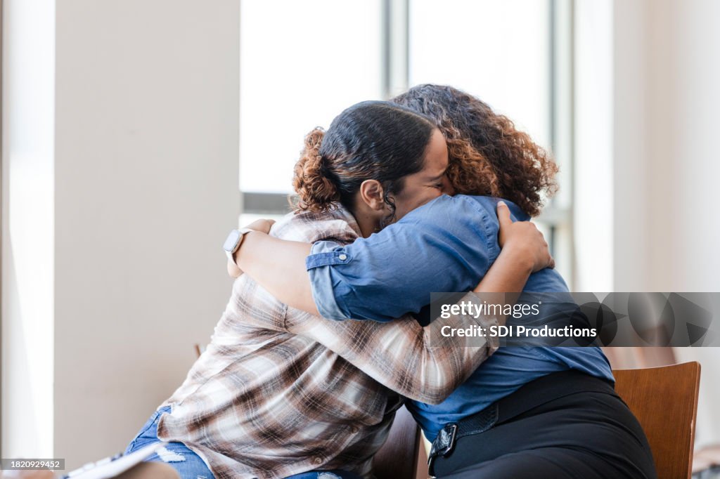 Mother and daughter hug each other during their counseling session