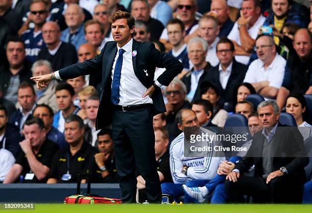 Andre Villas-Boas manager of Tottenham Hotspur signals as Jose Mourinho manager of Chelsea looks on during the Barclays Premier League match between...