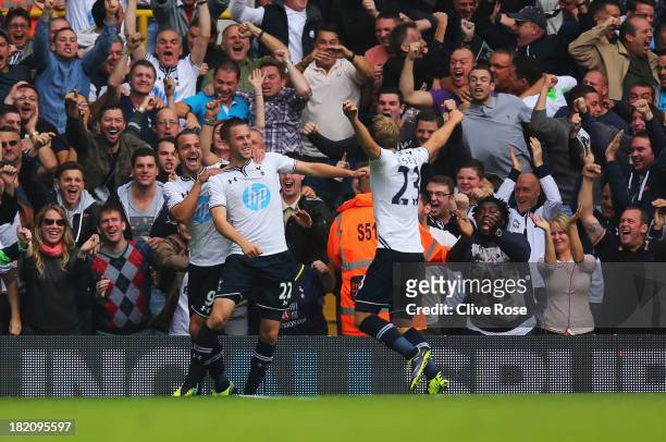 Gylfi Sigurdsson of Tottenham Hotspur celebrates in front of fans with Roberto Soldado and Christian Eriksen during the Barclays Premier League match...