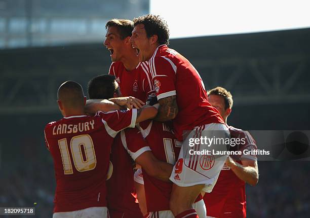 Jack Hobbs of Nottingham Forest is mobbed by Chris Cohen and Darius Henderson after scoring the opening goal during the Sky Bet Championship match...