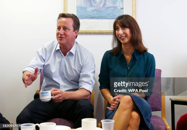 British Prime Minister David Cameron and his wife Samantha Cameron speak to cancer patients during a visit to the children's cancer ward at the John...