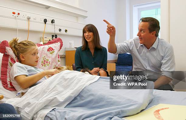 Britain's Prime Minister David Cameron and his wife Samantha talk to Scarlett Clarkson during a visit to the children's cancer ward at the John...