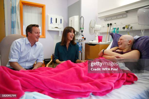 Britain's Prime Minister David Cameron and his wife Samantha talk to Chase Howie during a visit to the children's cancer ward at the John Radcliffe...