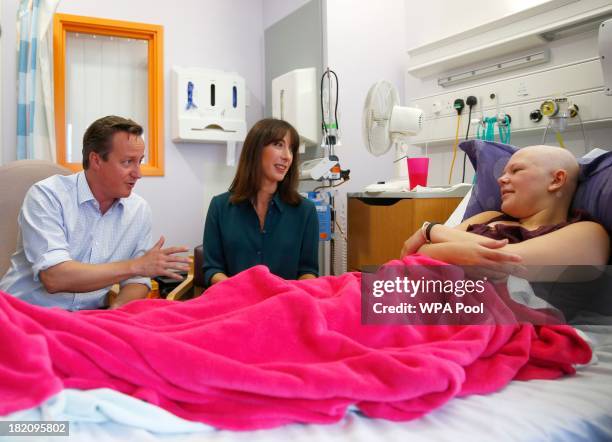 Britain's Prime Minister David Cameron and his wife Samantha talk to Chase Howie during a visit to the children's cancer ward at the John Radcliffe...