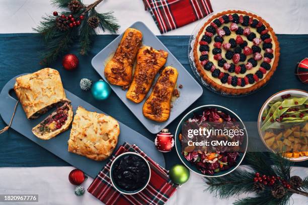 christmas dinner with vegan mushroom beef wellington, butternut squash, green beans and berry pie - christmas mince pies stock pictures, royalty-free photos & images