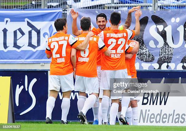 Elton da Costa of Darmstadt celebrates his team's first goal with team mates during the third Bundesliga match between 1. FC Saarbruecken and...