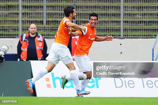 Elton da Costa of Darmstadt celebrates his team's first goal with team mate Aytac Sulu during the third Bundesliga match between 1. FC Saarbruecken...