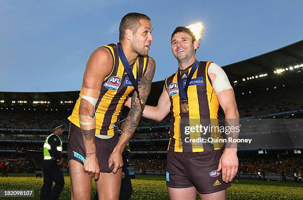 Lance Franklin and Brent Guerra of the Hawks celebrate winning the 2013 AFL Grand Final match between the Hawthorn Hawks and the Fremantle Dockers at...